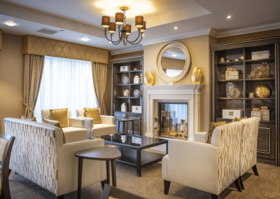Interior picture of a residential care home, featuring calming and comfortable furniture in a range of rooms, to support senior living.