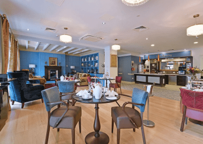 Interior picture of a residential care home, featuring calming and comfortable furniture in a range of rooms, to support senior living.
