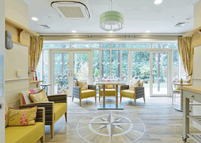 Interior picture of a residential care home, featuring calming and comfortable furniture in a range of rooms, to support senior living.