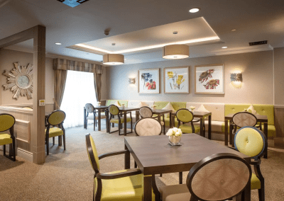 Interior picture of a residential care home, featuring calming and comfortable furniture in a range of rooms, to support senior living.