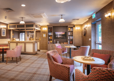 Interior picture of a residential care home, featuring calming and comfortable furniture in a range of rooms, to support senior living.