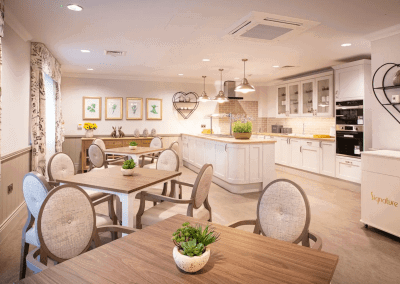 Interior picture of a residential care home, featuring calming and comfortable furniture in a range of rooms, to support senior living.
