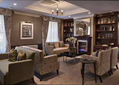 Interior picture of a residential care home, featuring calming and comfortable furniture in a range of rooms, to support senior living.