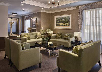 Interior picture of a residential care home, featuring calming and comfortable furniture in a range of rooms, to support senior living.