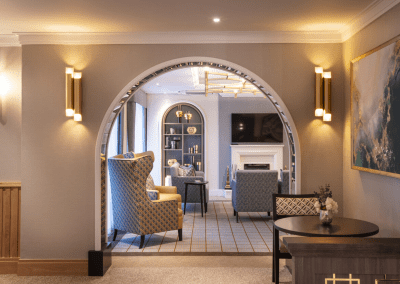 Interior picture of a residential care home, featuring calming and comfortable furniture in a range of rooms, to support senior living.