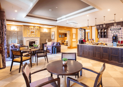 Interior picture of a residential care home, featuring calming and comfortable furniture in a range of rooms, to support senior living.