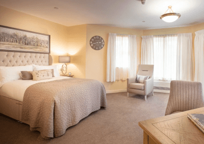 Interior picture of a residential care home, featuring calming and comfortable furniture in a range of rooms, to support senior living.