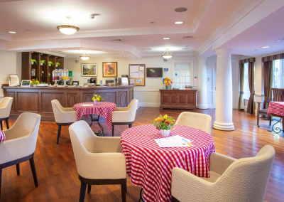 Interior picture of a residential care home, featuring calming and comfortable furniture in a range of rooms, to support senior living.