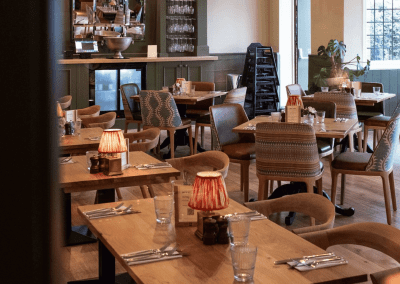 Bespoke pub furniture and soft furnishings at The Long Hop Pub, featuring comfortable seating, dining tables, and curtains designed to complement the venue’s warm, rustic interior.