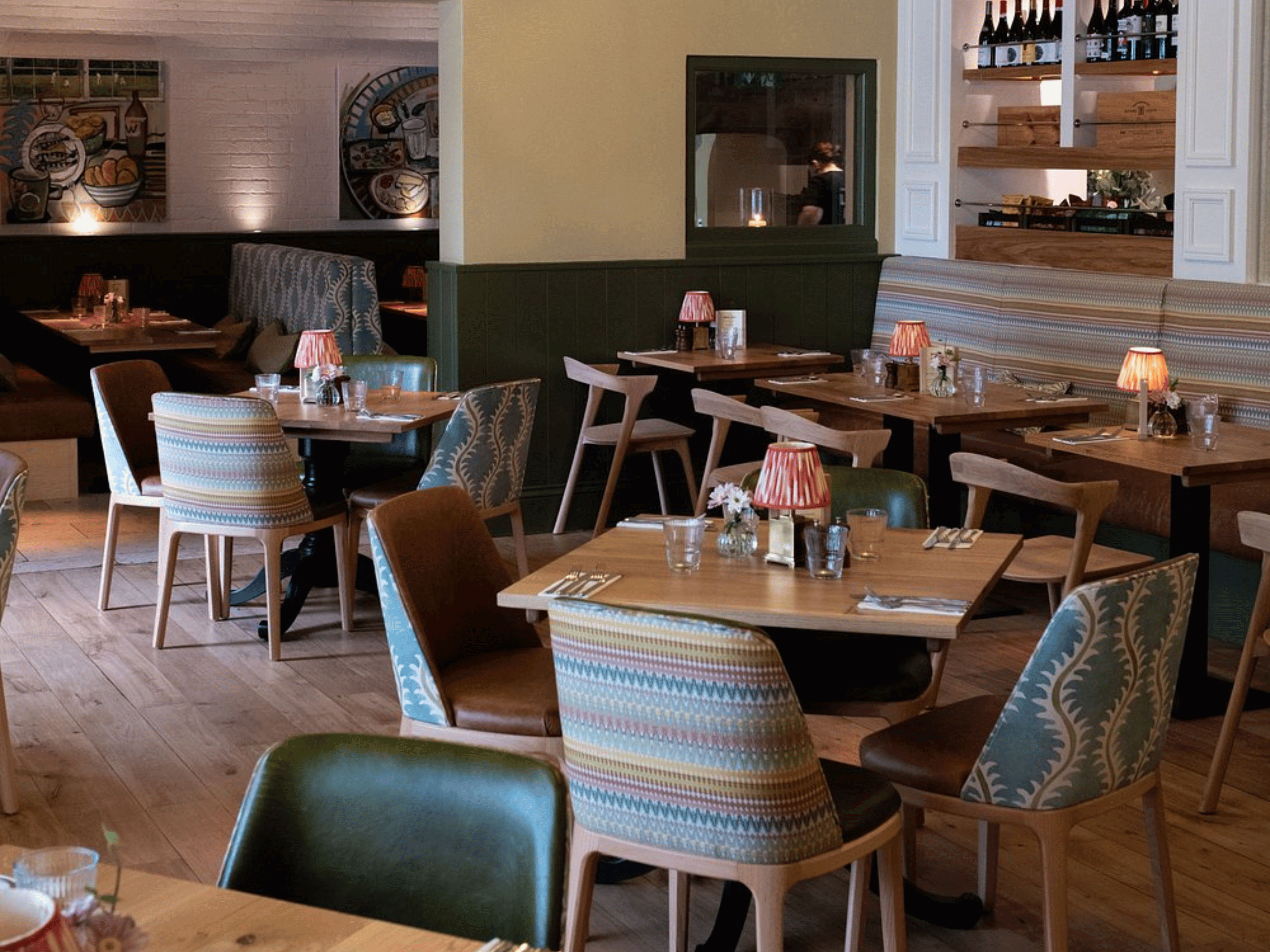 Bespoke pub furniture and soft furnishings at The Long Hop Pub, featuring comfortable seating, dining tables, and curtains designed to complement the venue’s warm, rustic interior.