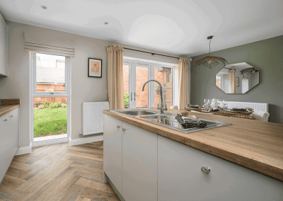 Interiors of show homes featuring bespoke curtains and blinds by Jameson Seating, complementing family-friendly, modern living spaces.