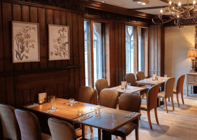 Bespoke pub furniture and soft furnishings featuring comfortable seating, dining tables, and curtains designed to complement the venue’s warm, rustic interior.