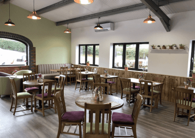 Bespoke café furniture featuring warm, rustic interiors and comfortable seating.